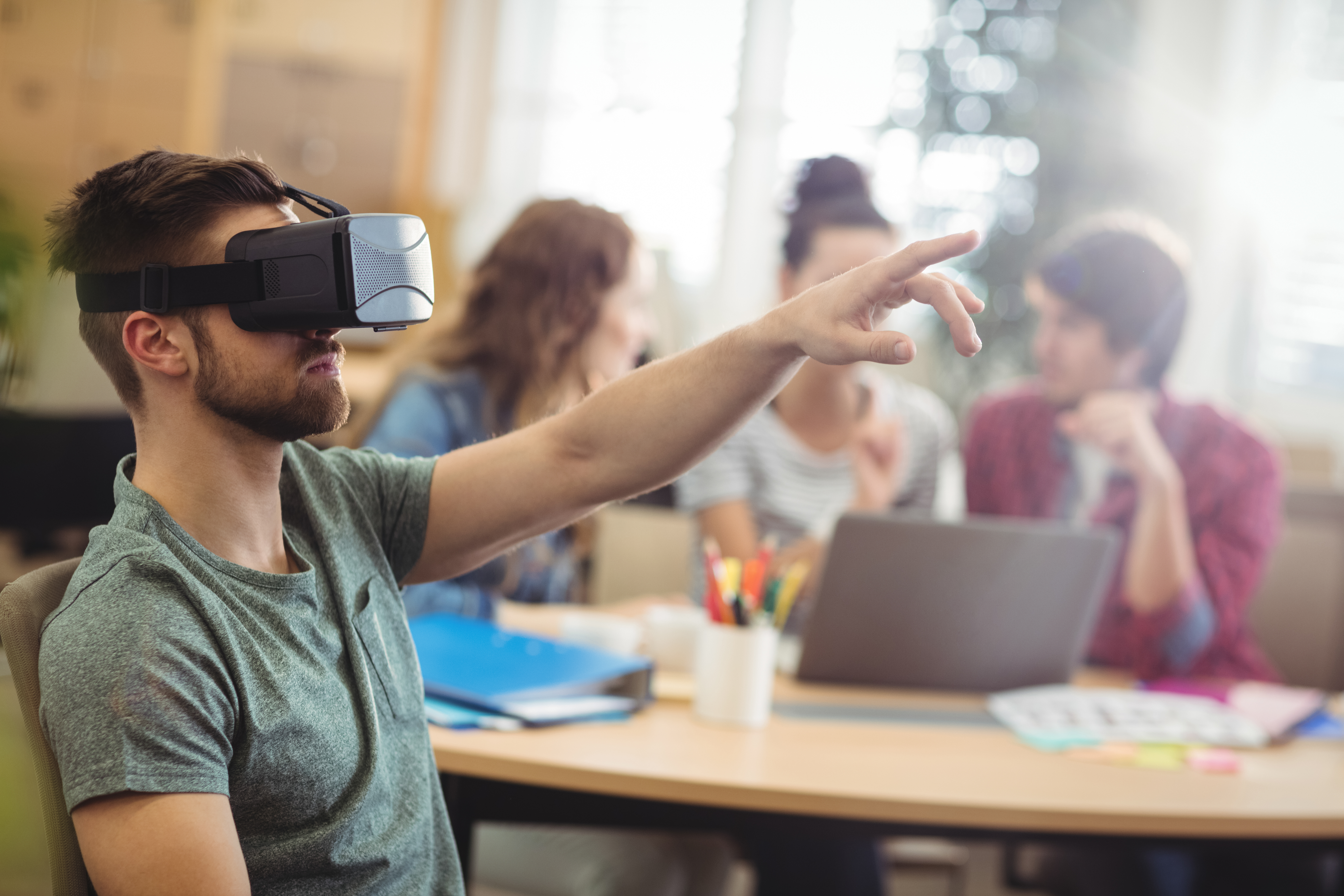 Male business executive using virtual reality headset in the office